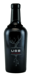 bottle of wine with black wax top, screen printed with grape vine and usb symbol and the words USB and Peltier Winery