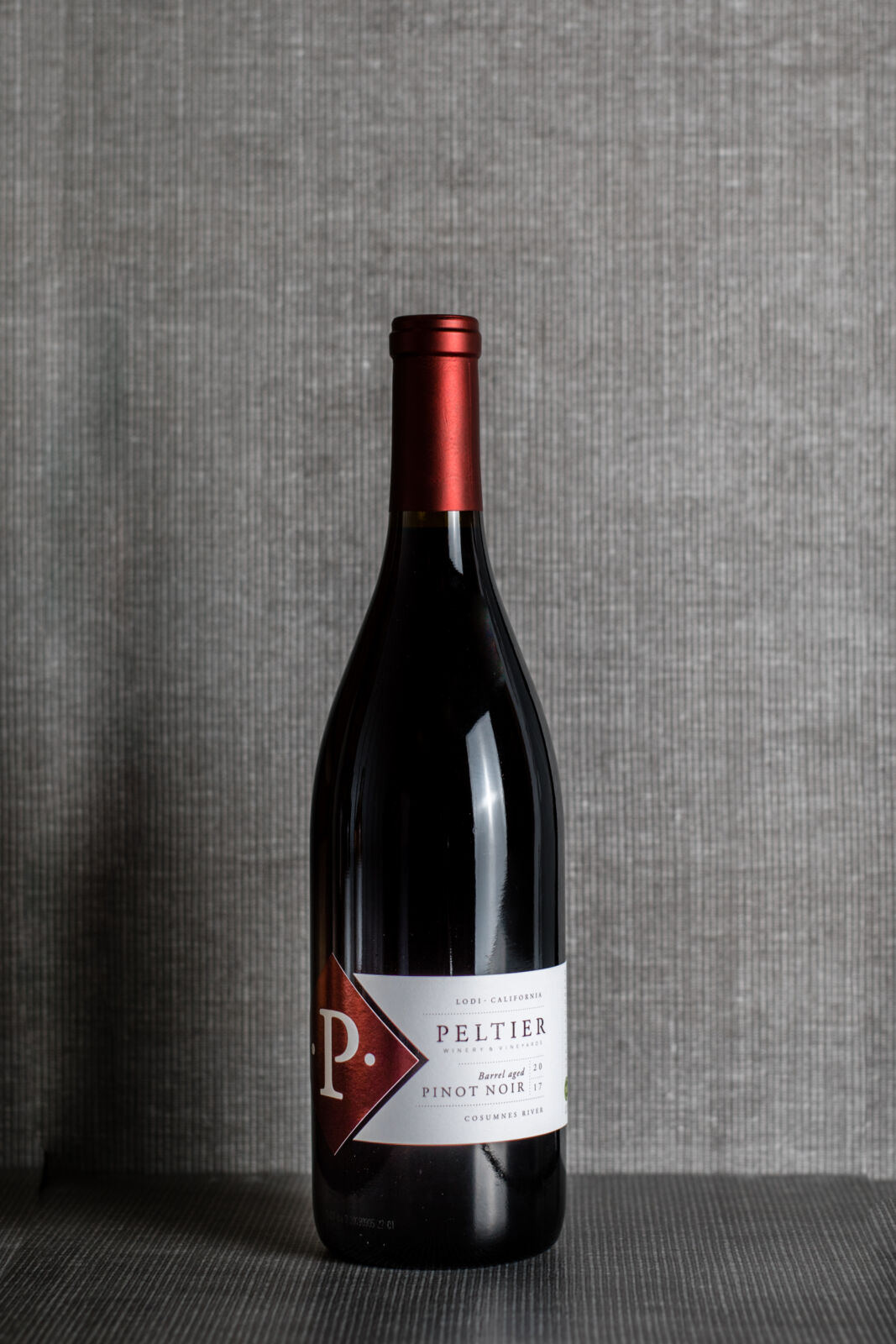 Pinot Noir bottle on grey background with black text over image Pinot Noir Diamond