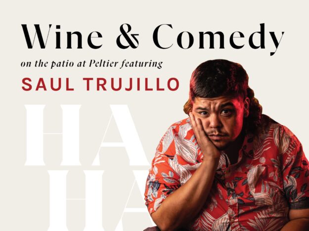 Wine and comedy on the Peltier patio featuring comedian Saul Trujillo photo of Saul with HA HA in the background